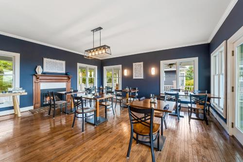 a dining room with tables and chairs and a fireplace at Inn at Brierley Hill in Lexington