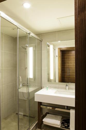 a bathroom with a sink and a glass shower at Bof Hotels Business in Istanbul
