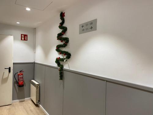 a hallway with a christmas wreath on the wall at Hostal BESTPRICE Barcelona Stadium in Barcelona