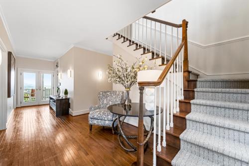 a living room with stairs and a table at Inn at Brierley Hill in Lexington