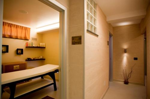 a bathroom with a walk in shower next to a table at 'A Nuciara Park Hotel & Spa in Furci Siculo