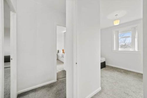 a room with white walls and a window at BridgeCity Hidden Gem in the heart of Falkirk Roughland house Stirlingshire in Carron