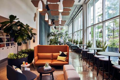 a lobby with a couch and tables and chairs at YOTEL Boston in Boston