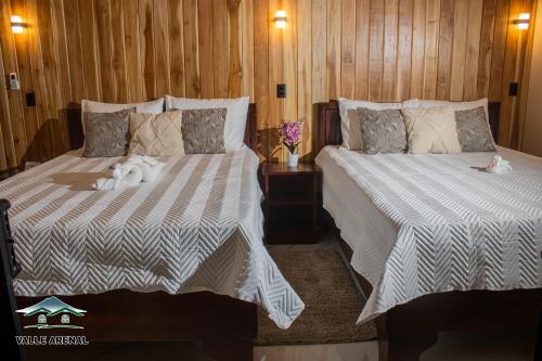 a bedroom with two beds with stuffed animals on them at Valle Arenal in Fortuna