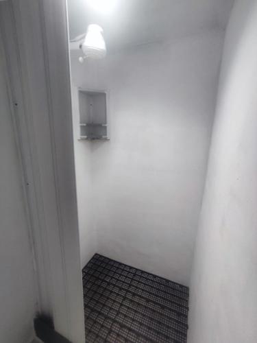 a small room with a white wall and a light at Hostel Princess Copacabana in Rio de Janeiro