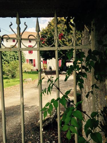 a metal fence with a house in the background at Gites les Lignons in Champniers