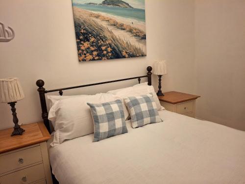 a bedroom with a bed with two pillows at Fenkle Street Alnwick Apartment in Alnwick