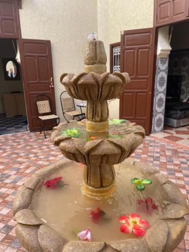 a fountain in the middle of a room at Dar MIMA in Rabat