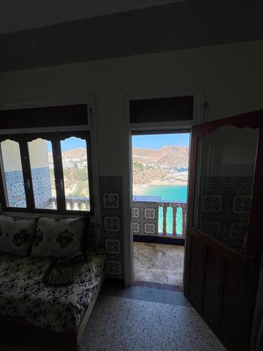 a room with two windows and a view of the ocean at Elhociema Qeumado in Al Hoceïma