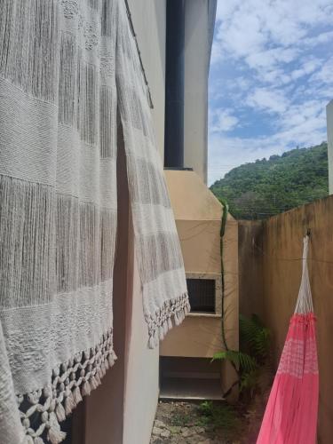 a view from the balcony of a house with a curtain at Lar Suave Lar in Florianópolis