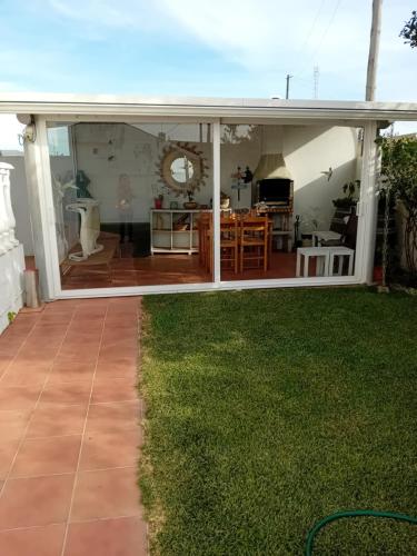 a large glass extension of a house with a patio at Casa Lagoa Verde in Esmoriz