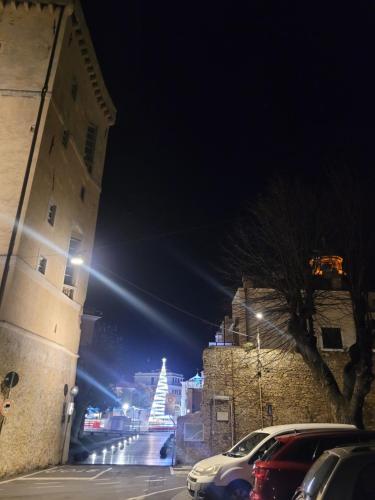 a city street at night with a christmas tree at Appartamento vacanze mare Loano in Loano