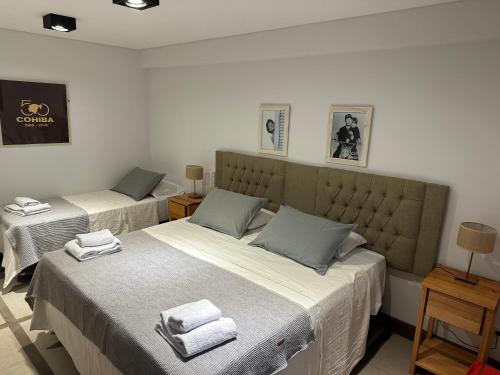 a bedroom with two beds with towels on them at San Germán de Muñiz in Muñiz