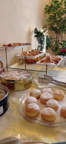 a buffet with donuts and other pastries on display at Hotel IL Rifugio in Gonzaga