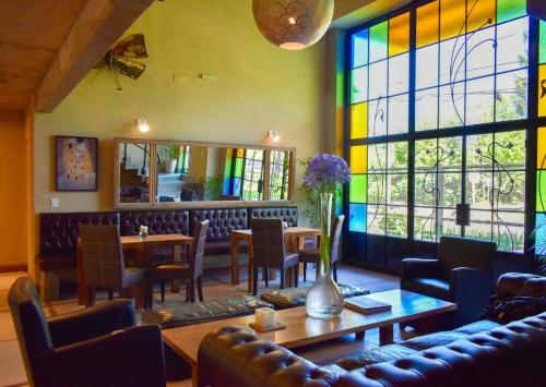 a restaurant with a table and chairs and a stained glass window at San Germán de Muñiz in Muñiz
