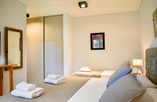 a bedroom with two beds with towels on them at San Germán de Muñiz in Muñiz