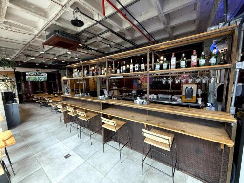 a bar with a row of tables and chairs at ibis Sao Paulo Ibirapuera in Sao Paulo
