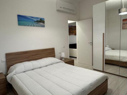 a bedroom with a large bed and a mirror at Sire Home in Aranova