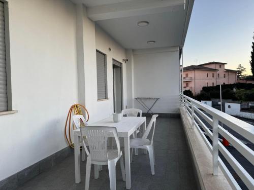 a white table and chairs on a balcony at Sire Home in Aranova