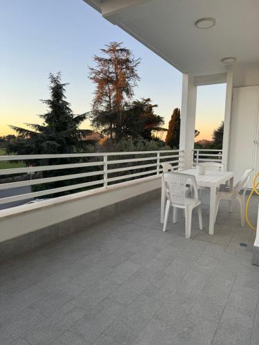 a patio with a table and chairs on a porch at Sire Home in Aranova