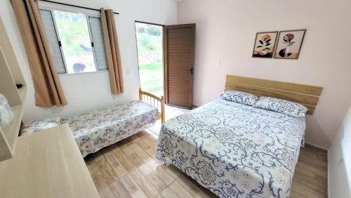 Кровать или кровати в номере Vale das Maritacas - Estilo Rural