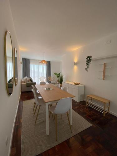 a dining room and living room with a table and chairs at Cantinho dos M&M in Funchal