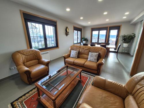 a living room with couches and a coffee table at Pensión Mariñeiro in Nigrán