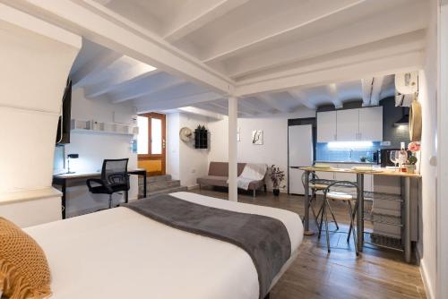a hotel room with a bed and a kitchen at Canals by Unik Vacation in Tarragona
