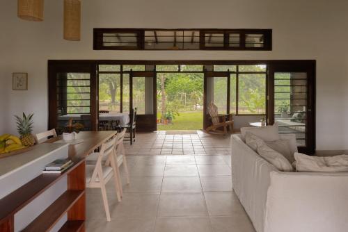 a living room with a couch and a table at Pedasi, Casa Alegre in Pedasi Airport