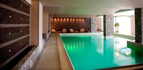 a swimming pool in a hotel with blue water at 'A Nuciara Park Hotel & Spa in Furci Siculo
