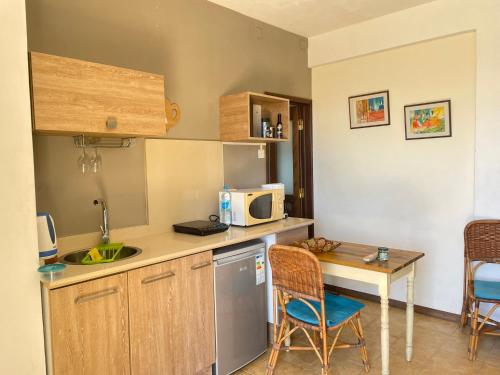 a small kitchen with a table and a microwave at Seahorse Appartments in Grand Baie