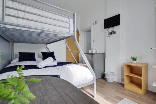 a bedroom with a bed with a metal canopy at Azure Beach Hotel in Bournemouth