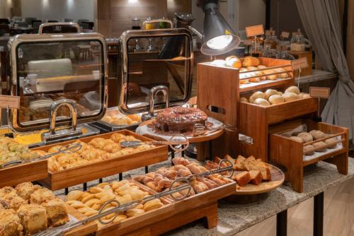 a bakery with many different types of pastries on display at Hilton Porto Alegre, Brazil in Porto Alegre