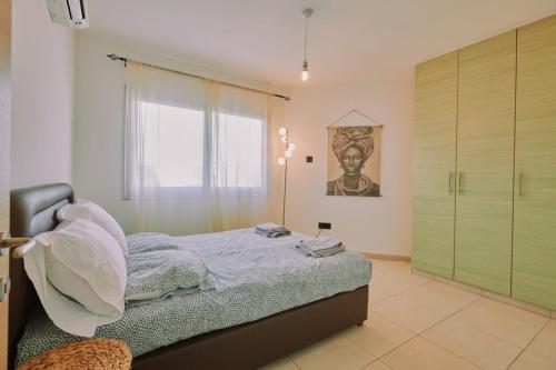 a bedroom with a bed with a green closet at Rosam Seaview Holiday apartment in Ayia Napa