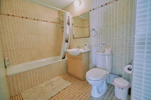 a bathroom with a toilet and a sink at Rosam Seaview Holiday apartment in Ayia Napa