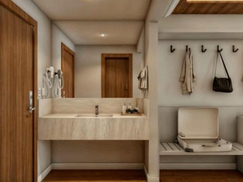 a bathroom with a sink and a mirror at Fazzenda Park Resort in Gaspar