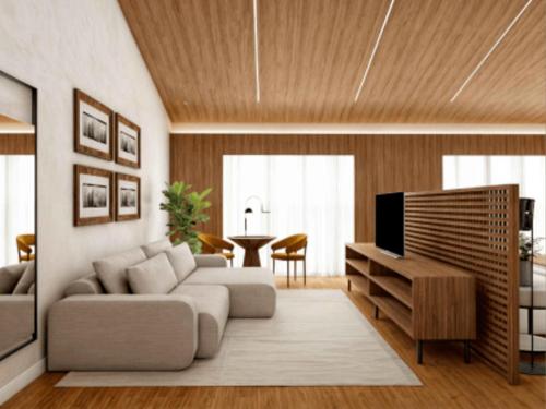 a living room with a couch and a television at Fazzenda Park Resort in Gaspar