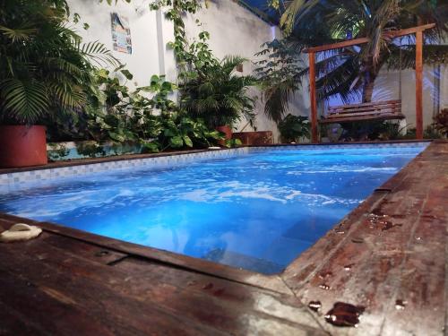 a swimming pool in a house with blue water at HOSTAL LA BOQUILLA in Cartagena de Indias