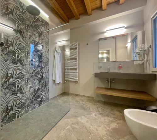 a bathroom with a sink and a mirror at Pietralunga Resort in Fidenza