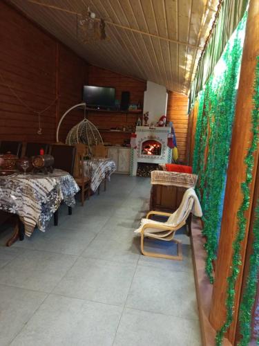 a room with a table and chairs and a fireplace at Gostynnyi Dvir u Marichky in Lazeshchyna