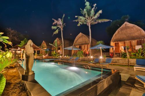 a pool at a resort at night at Sunset Coin Lembongan in Nusa Lembongan