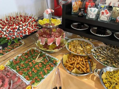 a buffet filled with lots of different types of food at Hotel Napoleon in San Mauro a Mare