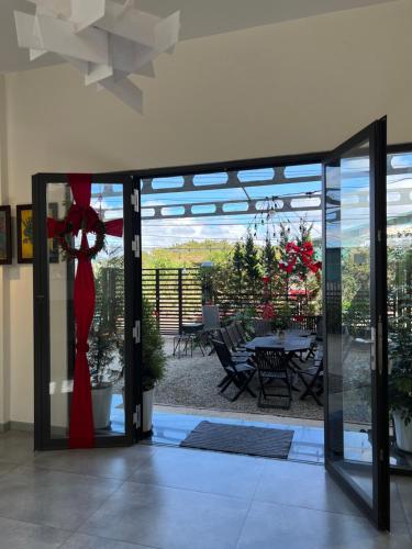 a glass door leading to a patio with a table at Villa Délight House “Stay&Chill” in Da Lat