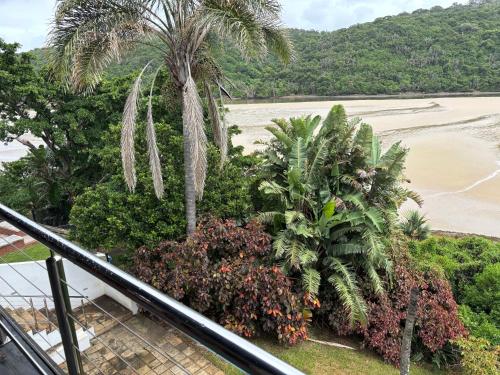 a view of the beach from the balcony of a resort at Aspire on Meier in East London
