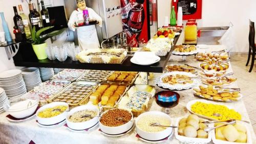 a buffet with many different types of food on a table at Hotel Napoleon in San Mauro a Mare