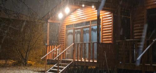 a log cabin with a staircase leading to a window at Cottage Talu in Mestia in Mestia