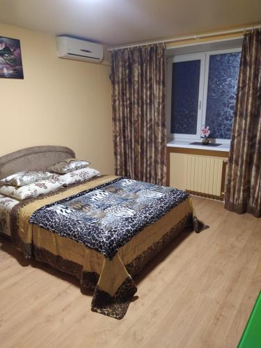 a bedroom with a bed in a room with a window at Центр район 5 школи Апартаменти in Poltava