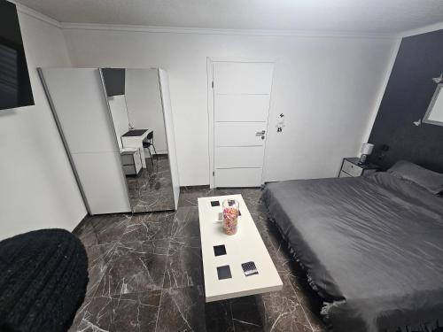 a bedroom with a bed and a table and a mirror at ENA 1&2 -BIG FREE PRIVAT parking for BOATS, TRUCKs, combi,-CENTRAL HEATING !!! in Karlovac