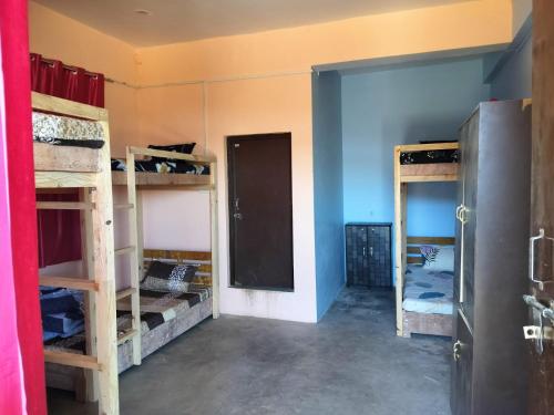 a room with several bunk beds in a room at Nirvana Heights Kasar Devi in Hawālbāgh