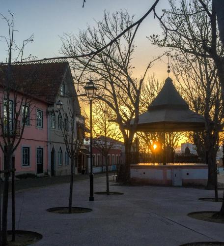 a park with a gazebo with a sunset in the background at Carnide 1913 D - 1BR apt in Lisbon